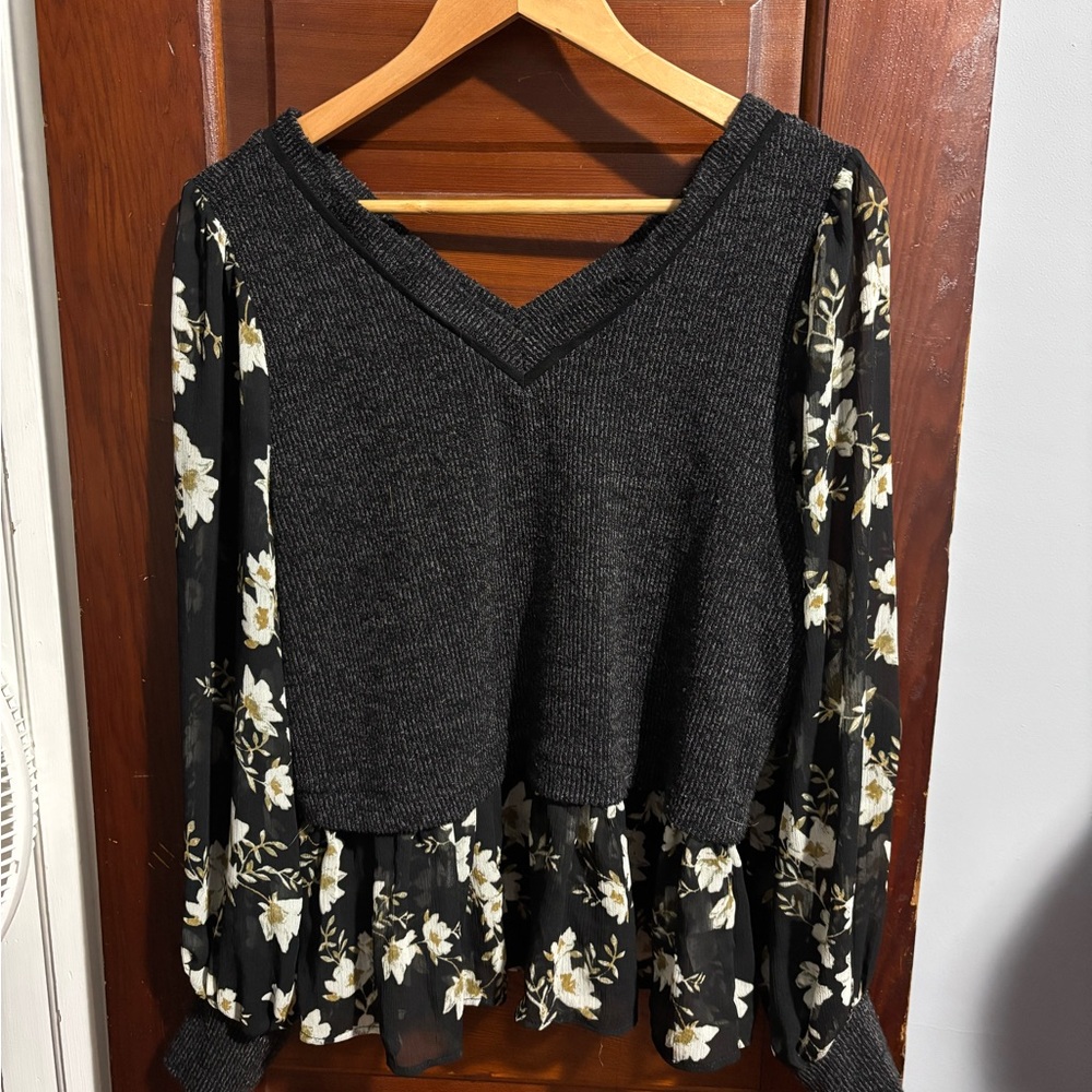 Maurice’s dark grey sweater with sheer sleeves